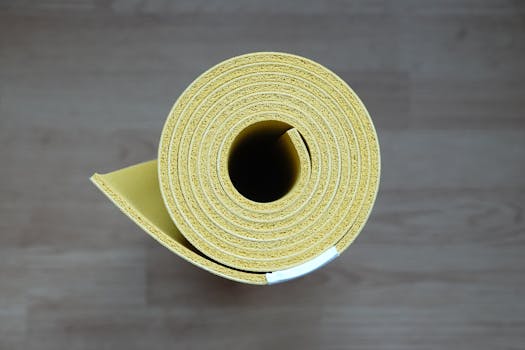 Close-up of a rolled yellow yoga mat, ideal for fitness enthusiasts and interior design.