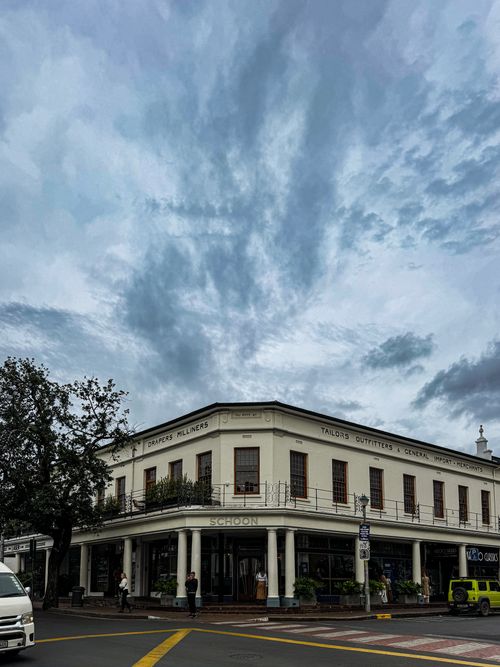 Free A vintage corner building under a dramatic sky in Stellenbosch, South Africa. Stock Photo