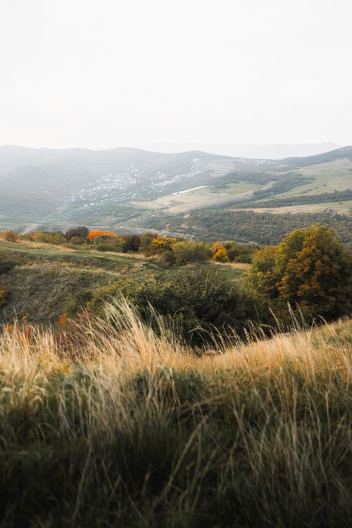 Free Beautiful sweeping view of autumn hills and valleys under a bright sky. Stock Photo