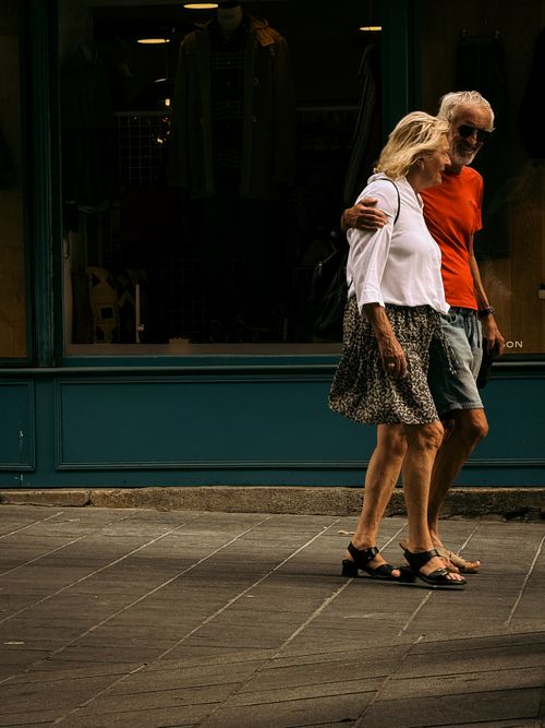 Free An elderly couple walking arm-in-arm on a Bordeaux street, France, enjoying a peaceful day out. Stock Photo