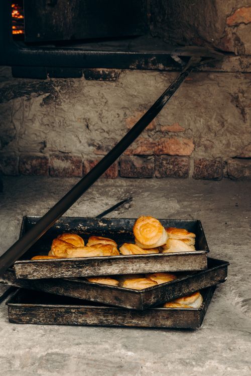 Free Freshly baked bread rolls in a traditional stone oven in Hyderabad, Sindh. Stock Photo