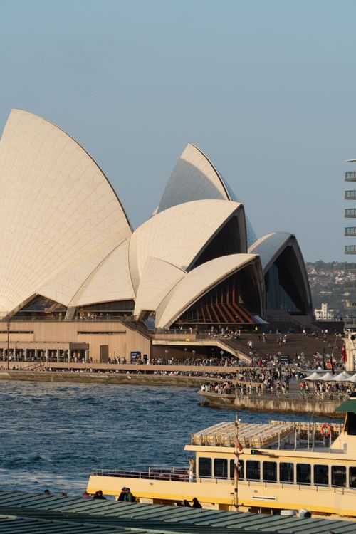 Free A stunning view of the Sydney Opera House during the day with a nearby ferry and waterfront atmosphere. Stock Photo