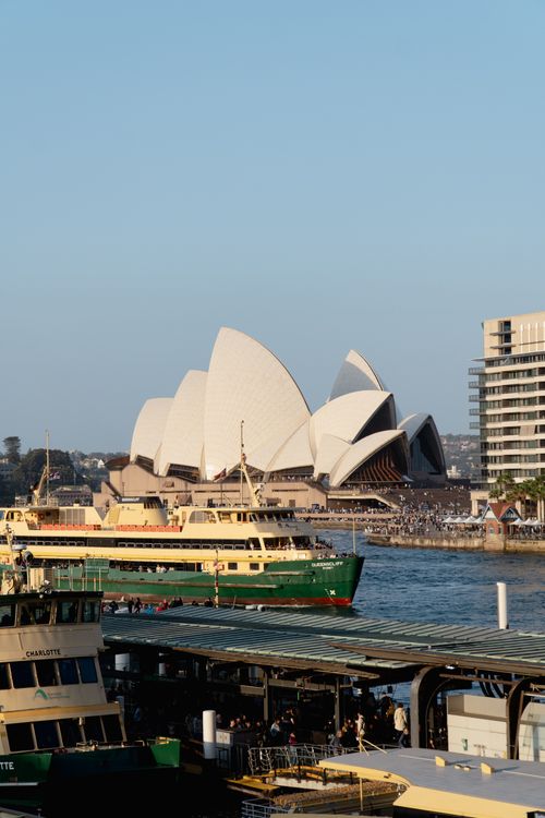 Free Scenic view of Sydney Opera House from the harbor with ferries in foreground. Stock Photo