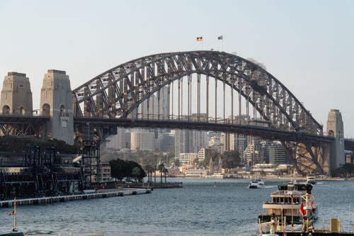 Free Iconic Sydney Harbour Bridge captured on a sunny day with boats in the foreground. Stock Photo