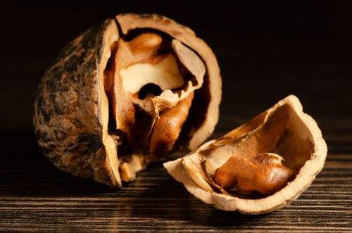 Free Detailed macro shot of a cracked walnut showing the texture of the shell and the nut inside. Stock Photo