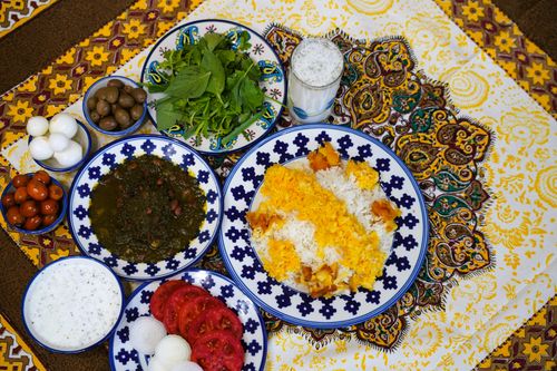 Free Colorful Persian meal featuring rice, herbs, and traditional delicacies. Stock Photo