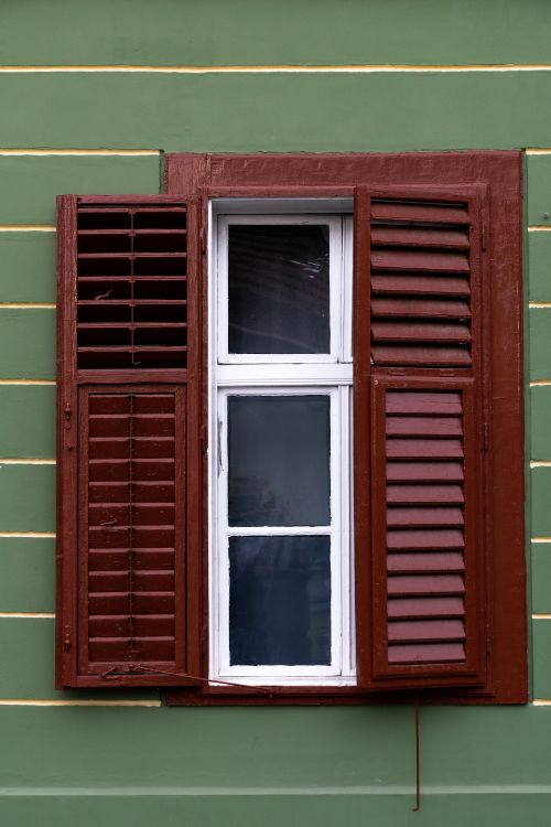 Free Close-up of a classic window with shutters in Sibiu, Romania. Stock Photo