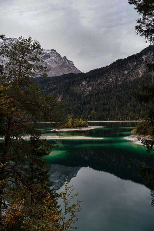 Free Tranquil view of a pristine lake surrounded by the Bavarian Alps in Germany. Stock Photo
