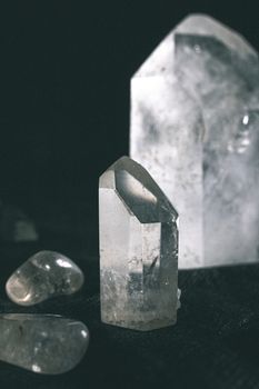 Clear quartz crystals in various shapes on a black background for a mystical vibe.