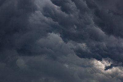 Dark rain clouds over open water — photo by Lucas Pezeta on Pexels