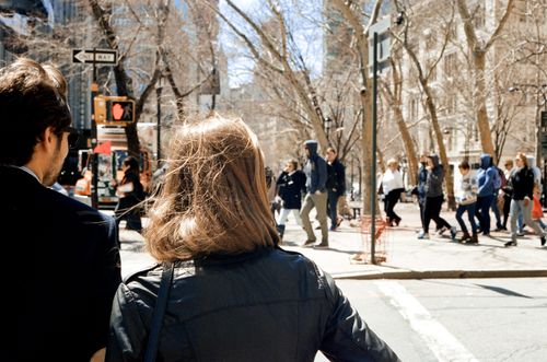 Free A busy street scene in a city with pedestrians walking on a sunny day. Stock Photo
