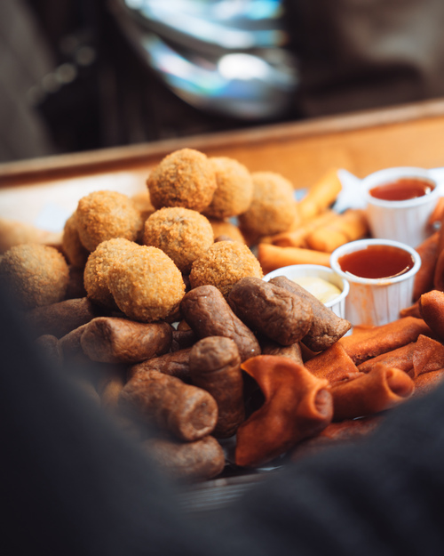 Free A close-up of a Dutch appetizer platter featuring bitterballen and sauces. Stock Photo