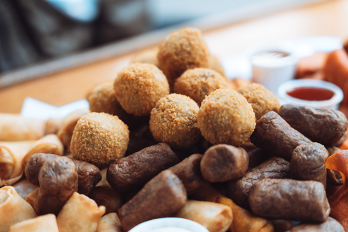 Free Enjoy a variety of Dutch finger foods, including bitterballen, on a platter outdoors in Amsterdam. Stock Photo
