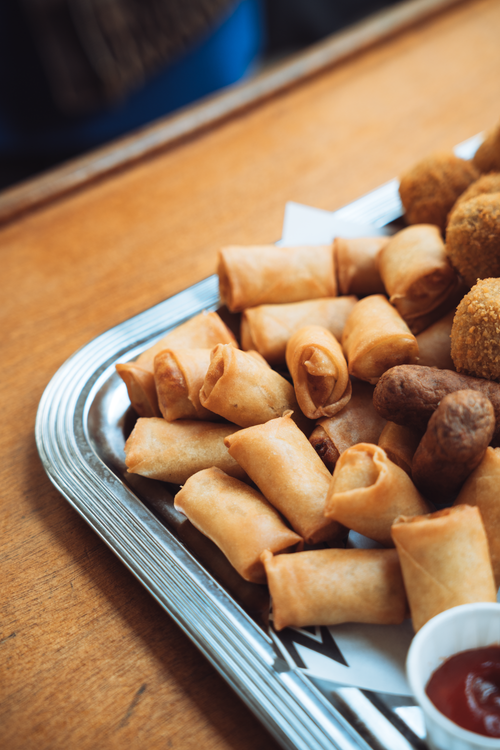 Free A close-up of a Dutch snack platter with bitterballen, frikandelletjes, and kaasstengels served with sauce in Amsterdam. Stock Photo