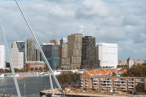 Free View of Rotterdam's skyline featuring modern architecture and cityscape along the river. Stock Photo