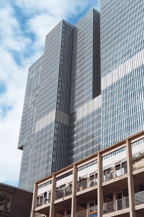 Free Tall contemporary skyscraper with a clear blue sky in Rotterdam Stock Photo