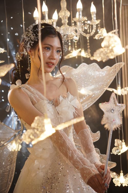 Free A young woman dressed as a fairy with ethereal lights and decorations. Stock Photo