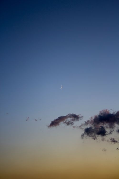 Free Tranquil twilight sky featuring a crescent moon and gentle clouds, perfect for calm and peaceful themes. Stock Photo