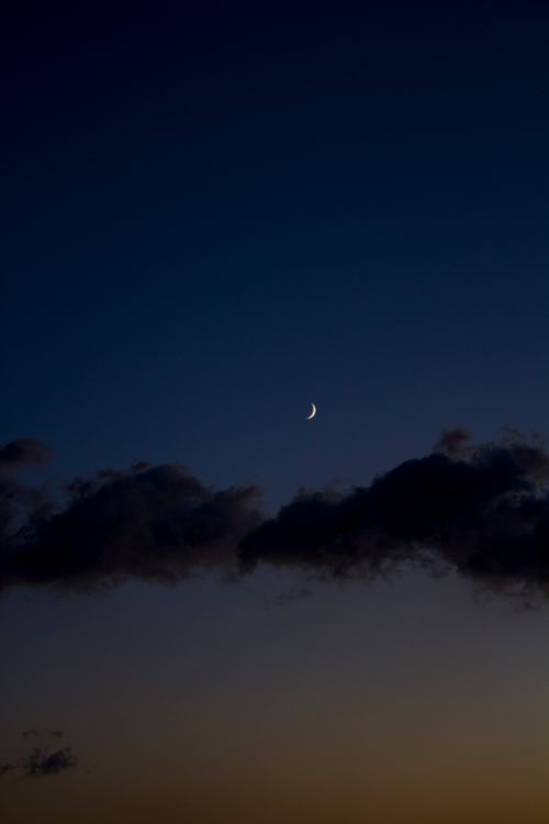 Free Serene crescent moon in a twilight sky over Tangier, Morocco. Perfect for tranquil themes. Stock Photo