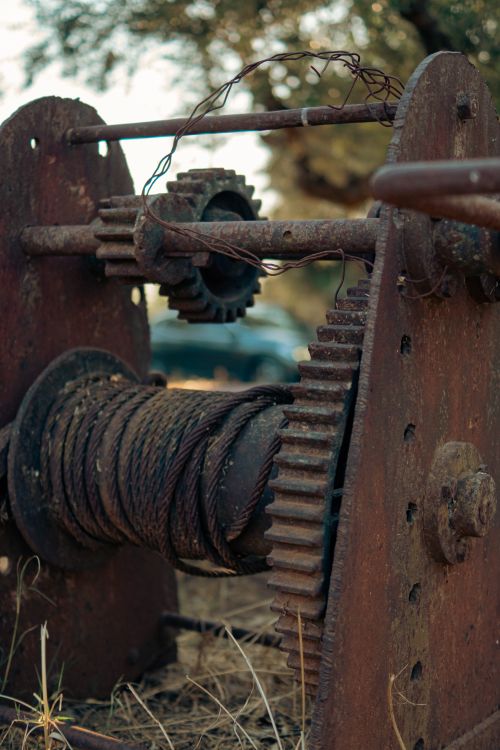 Free A close-up of a rusted industrial gear system outdoors, showcasing weathered metal details. Stock Photo