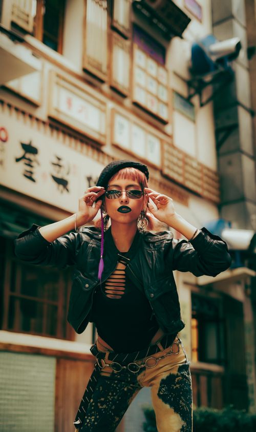 Free Stylish young adult posing confidently in a trendy urban street scene, exuding modern fashion vibes. Stock Photo