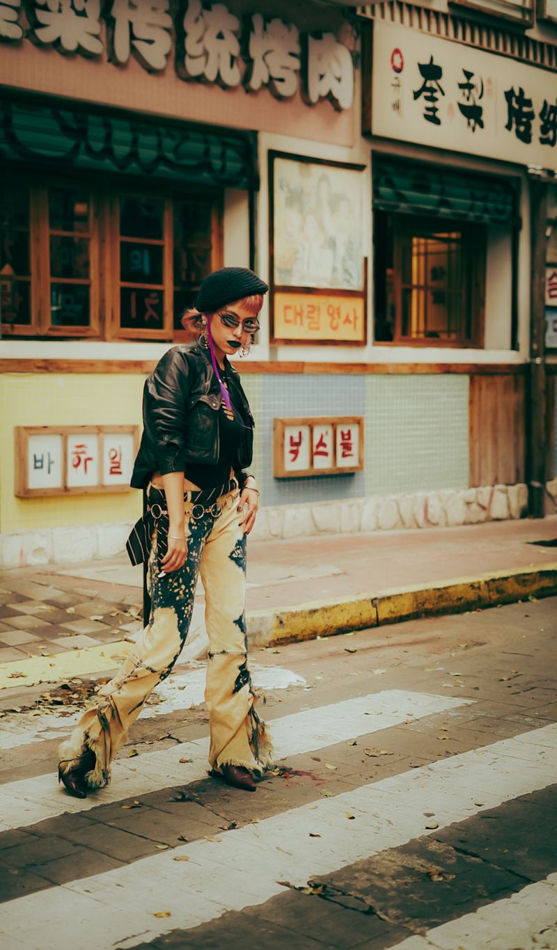 Woman in edgy Korean street-style outfit with leather jacket and beret