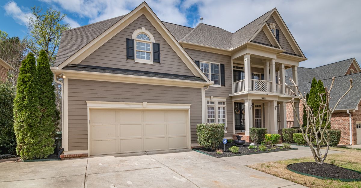 A beautiful suburban home with a spacious front garage and manicured lawns.