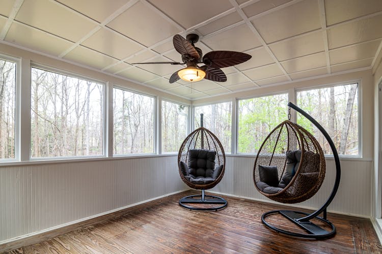 Ceiling Fan And Egg Chairs Inside A Room