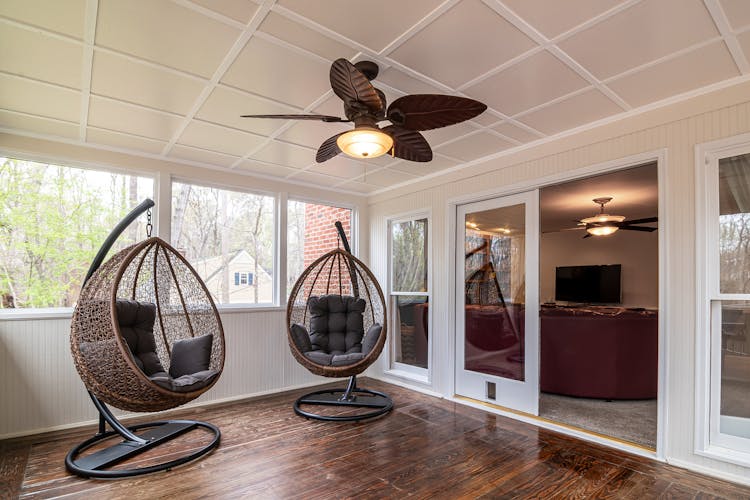 Egg Chairs And Ceiling Fan In A Room