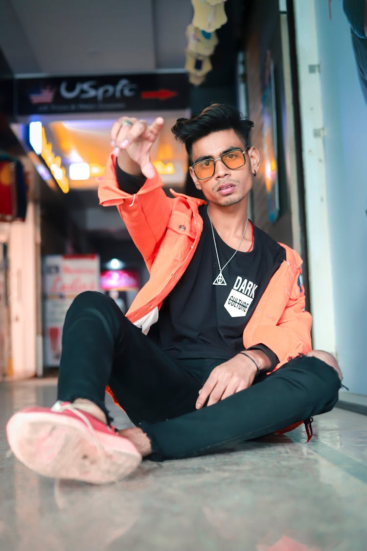 Stylish Fit Man In Eyeglasses Sitting On Floor