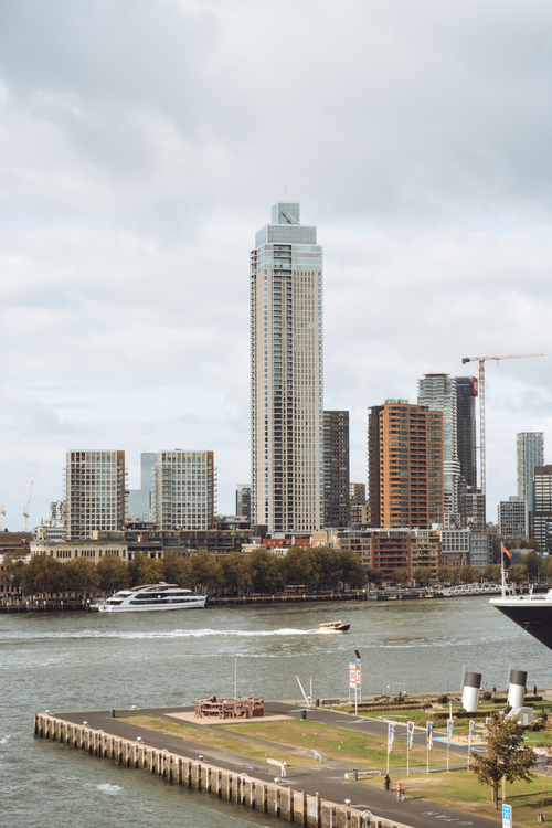 Free Skyline view of modern skyscrapers in Rotterdam along the river, capturing urban architecture. Stock Photo