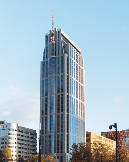 Free Stunning view of a modern skyscraper in Rotterdam with clear blue sky backdrop. Stock Photo
