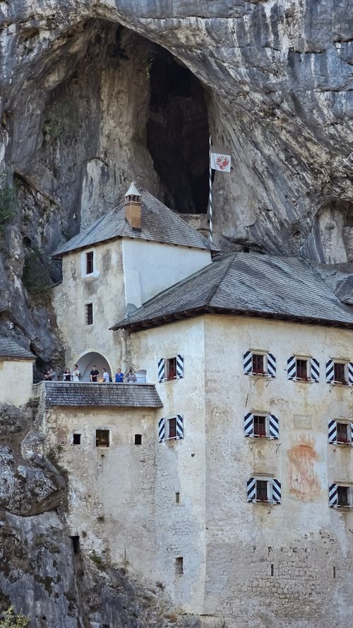 Free Explore the majestic Predjama Castle nestled in a Slovenian cave, showcasing medieval architecture. Stock Photo