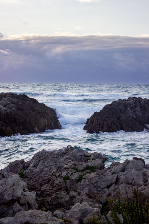 Free Rocky coastline of Cantabria, Spain with dramatic skies and rough seas. Majestic and wild scenery. Stock Photo