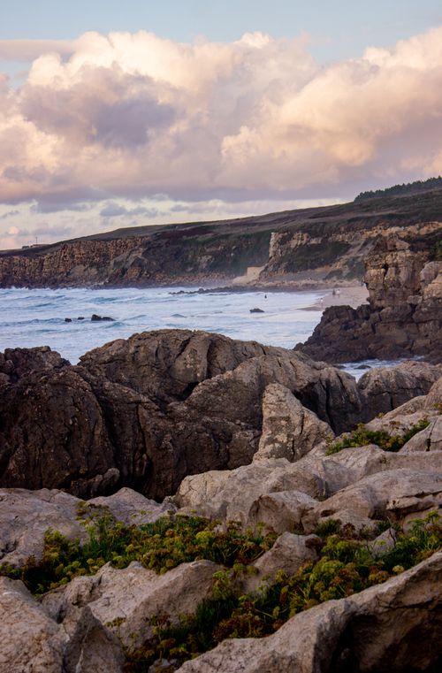 Free Picturesque rocky shoreline with waves and cliffs under a cloudy sky in Cantabria. Stock Photo