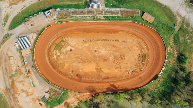 Drone View Of Bright Open Sandy Pit Near Growing Trees