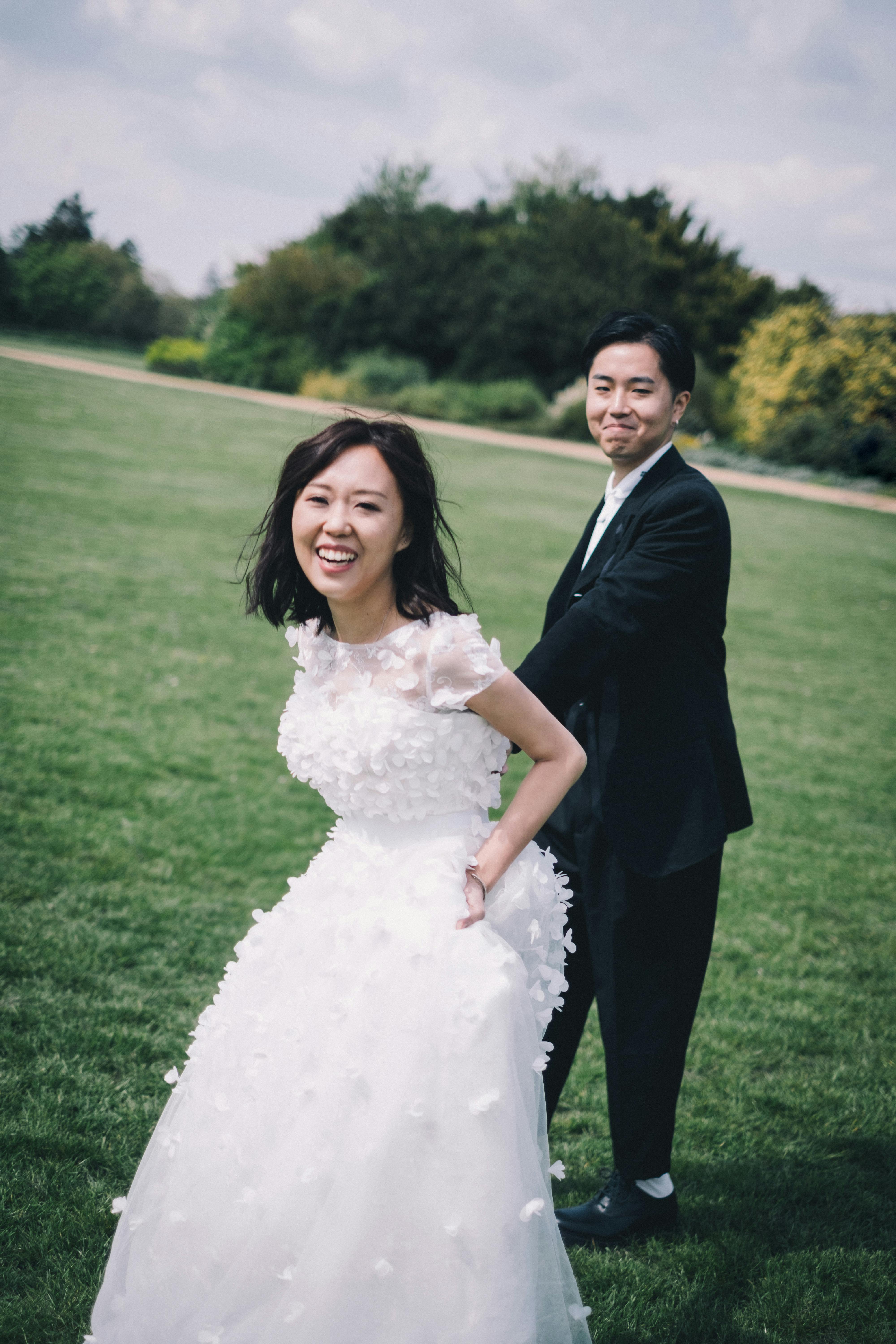 cheerful newlywed asian couple in nature