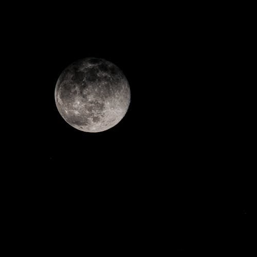 Full moon shining on black background