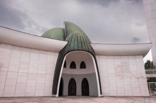 Free Explore the unique architectural design of a modern mosque in Croatia with green domes and ornate exterior. Stock Photo