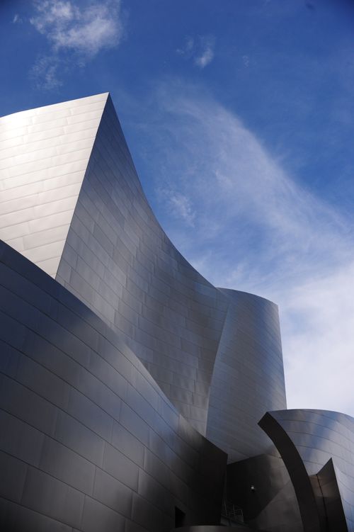 Free Stunning view of modern architecture with sleek curves against a clear blue sky. Stock Photo