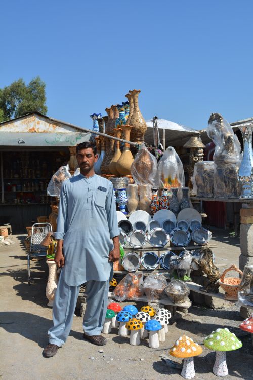 Free Explore traditional crafts at a roadside market in Taxila, Pakistan with vibrant pottery and local artistry. Stock Photo