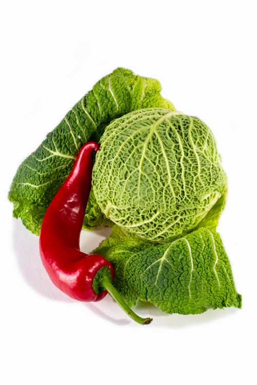 Free Fresh green cabbage paired with a vibrant red chili pepper. Stock Photo