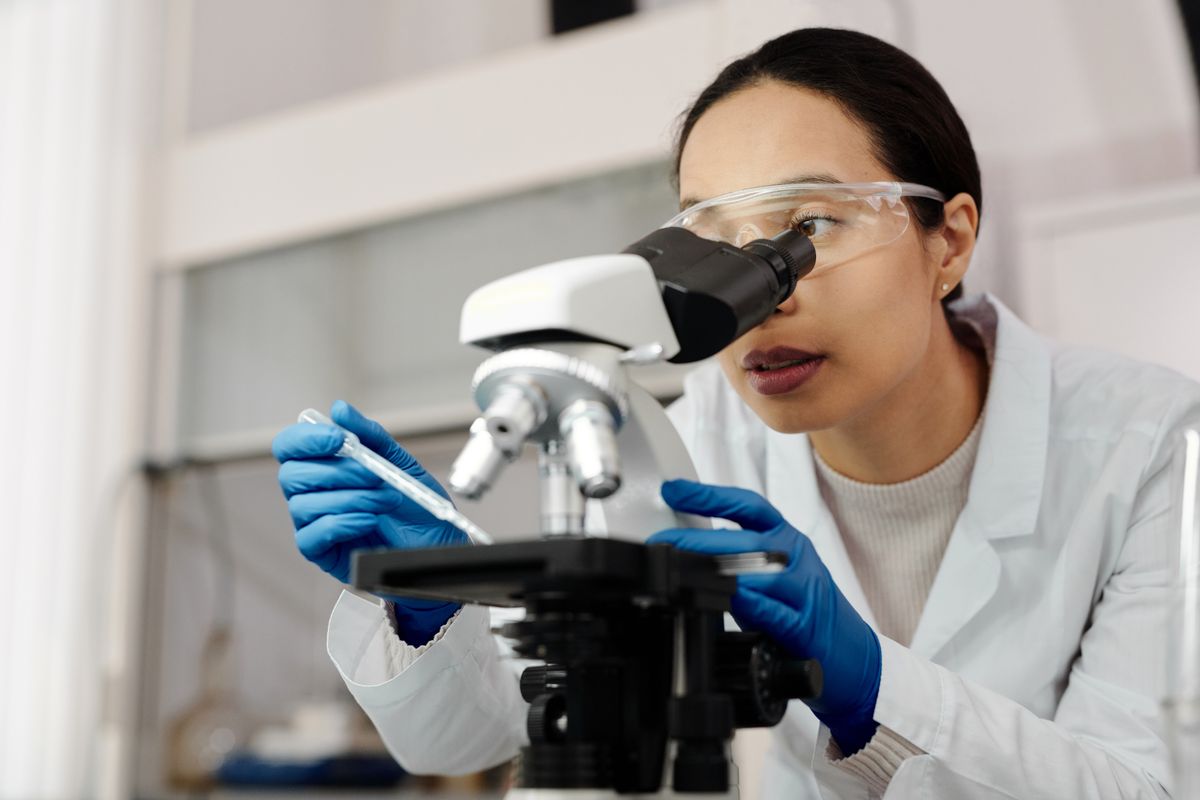 A scientist using a microscope in a laboratory