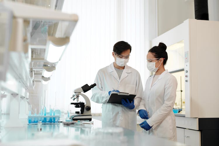 Two Scientists Working Inside The Laboratory