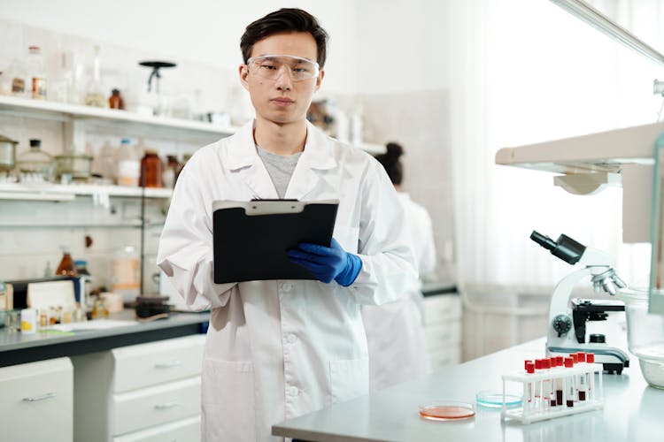 Male Scientist In White Lab Coat Working In A Laboratory