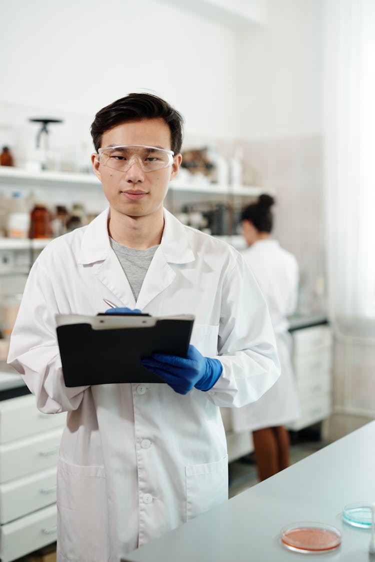 Male Scientist In White Lab Coat Working In A Laboratory