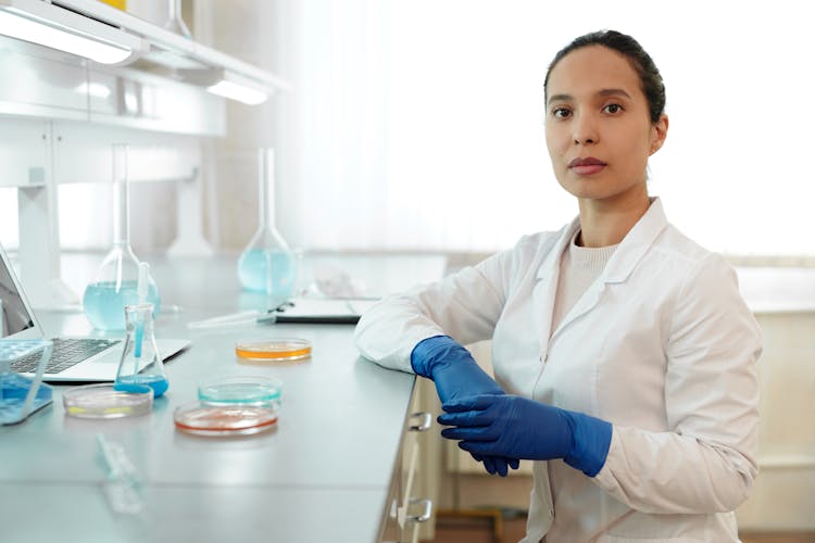 Female Scientist In White Lab Coat Working In A Laboratory