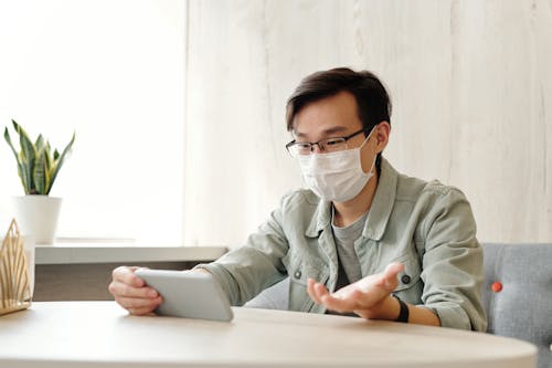 Man Wearing Face Mask while Having a Video Call