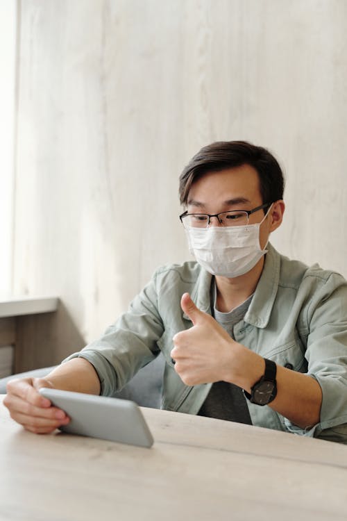 Man Wearing Face Mask while Having a Video Call