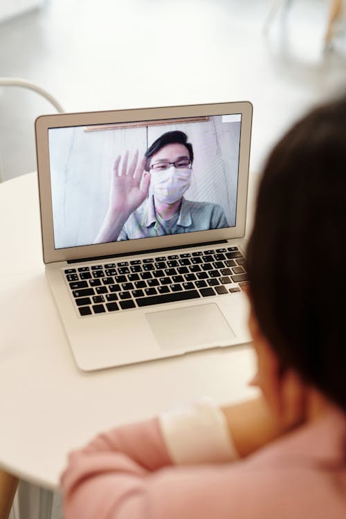 Free Man Wearing Face Mask while Having a Video Call Stock Photo